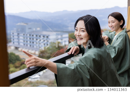 Women's trip, hot spring inn, woman looking at outdoor scenery Women's trip, hot spring inn, woman looking at outdoor scenery 134011363