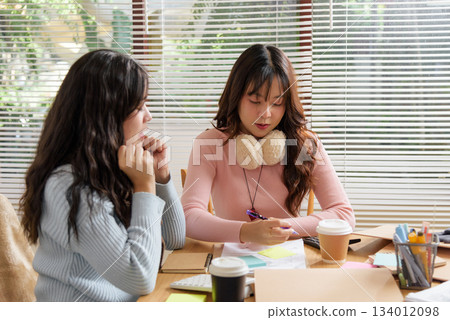 Busy people meet for office work, young business team consult financial data, work together, discuss ideas, planning project strategy, professional collaboration setting with documents and coffee. 134012098