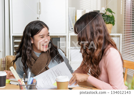 Young business women busy meet, people at office work as team, consulting financial plans, collaborating with focus and bright energy, discussing important project details achieving success. 134012143