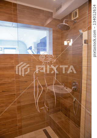 Modern shower cabin with artistic glass panel. Modern shower cabin with artistic glass panel. 134012614