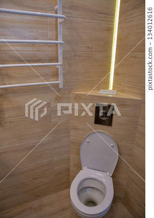 Modern bathroom interior with wood tile and heated towel rack. 134012616