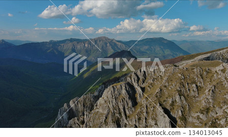 Rocky mountains and valley before sunset aerial Rocky mountains and valley before sunset aerial 134013045