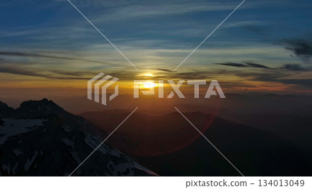 Rocky snow mountains at sunset aerial Rocky snow mountains at sunset aerial 134013049