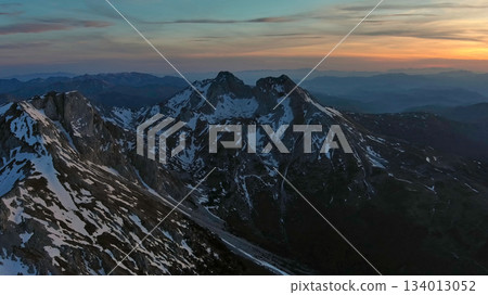 Rocky snow mountains at sunset aerial 134013052