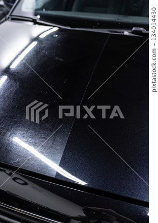 Paint correction before ceramic coating showing 50 50 comparison on car hood Paint correction before ceramic coating showing 50 50 comparison on car hood 134014430
