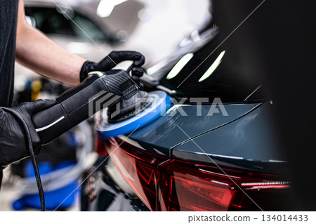 Machine polishing and paint correction of car body near taillight during professional car detailing Machine polishing and paint correction of car body near taillight during professional car detailing 134014433