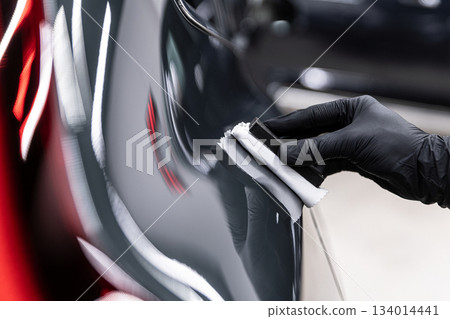 Ceramic coating application on car paint using applicator pad during professional car detailing Ceramic coating application on car paint using applicator pad during professional car detailing 134014441