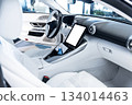 Modern car interior with white leather seats and blank touchscreen display copy space for advertising 134014463