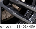 Wheel balancing weights mounted on aluminum alloy rim during professional tire and wheel service 134014469