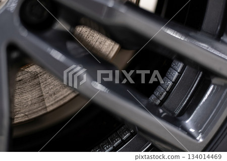 Wheel balancing weights mounted on aluminum alloy rim during professional tire and wheel service 134014469