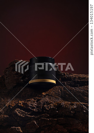 cosmetic jar sits on a textured wooden surface. The background is dark creating a strong contrast. The jar design is simple and modern. Light reflects softly on its surface. cosmetic jar sits on a textured wooden surface. The background is dark creating a strong contrast. The jar design is simple and modern. Light reflects softly on its surface. 134015197