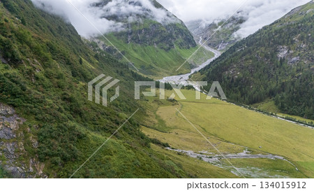 Aerial view on alpine valley with glacier river streaming between the mountains, Austrian Alps 134015912