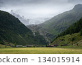 Picturesque alpine village nested in a valley with massive glacier above it, Austrian Alps 134015914