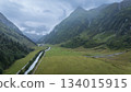 Aerial view on alpine valley with storm clouds approaching in the background, Austrian Alps 134015915