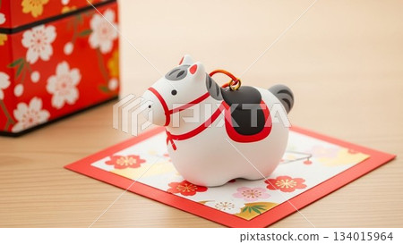A display of lucky charms for the New Year, featuring a zodiac rabbit figurine and a red background A display of lucky charms for the New Year, featuring a zodiac rabbit figurine and a red background 134015964