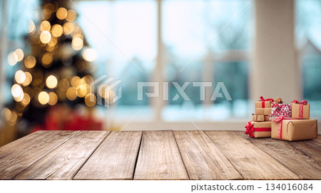 Beautifully wrapped gifts sit on a wooden table as a decorated Christmas tree shines in the background during the holiday season Beautifully wrapped gifts sit on a wooden table as a decorated Christmas tree shines in the background during the holiday season 134016084