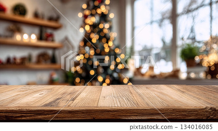 Wooden tabletop with blurred Christmas tree and warm lights in cozy room during festive season for holiday gatherings and celebrations 134016085