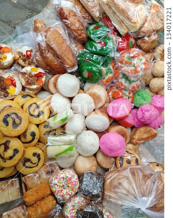 Assorted Pastries, Cookies, Macarons, and Sweets Displayed in Bags for Outdoor Market Sale Colorful Stall 134017221