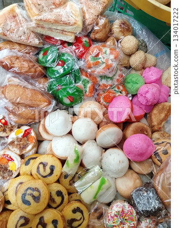 Assorted Pastries, Cookies, Macarons, and Sweets Displayed in Bags for Outdoor Market Sale Colorful Stall 134017222