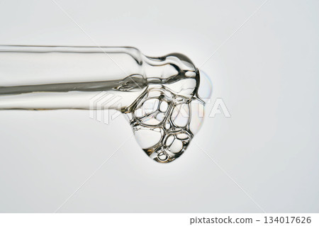 Cosmetic pipette dispensing serum with bubbles macro 134017626