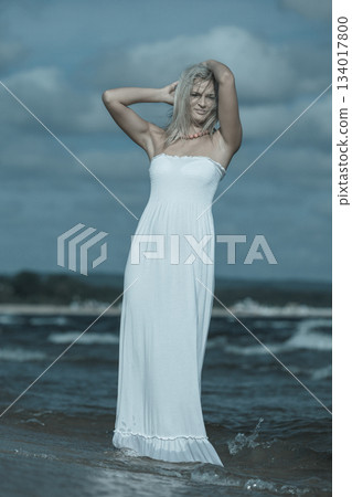 Young lady resting on beach. 134017800