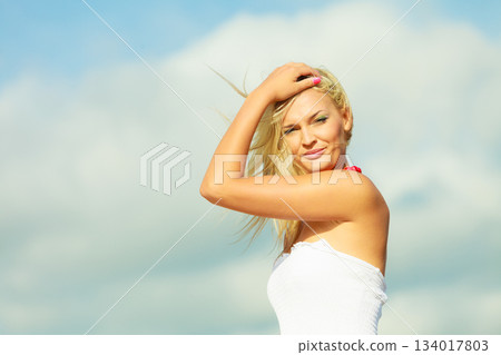 Beauty blonde woman portrait on sky background. Beauty blonde woman portrait on sky background. 134017803