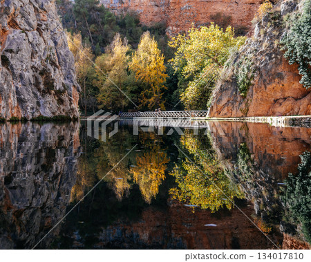 Monasterio de Piedra lake reflecting autumn trees and rock formations Monasterio de Piedra lake reflecting autumn trees and rock formations 134017810