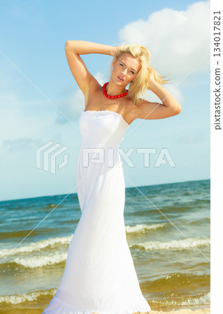 Girl taking walk on shore. 134017821