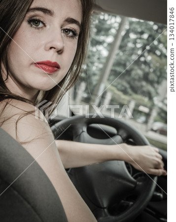 Stressed woman driving car Stressed woman driving car 134017846