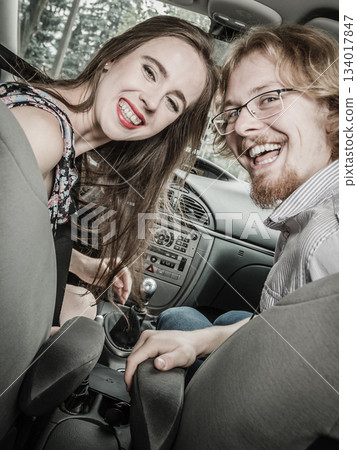 Happy man and woman in car Happy man and woman in car 134017847
