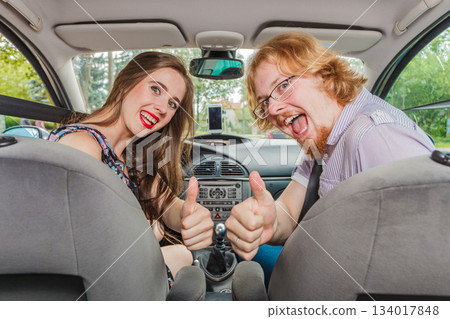 Happy man and woman in car Happy man and woman in car 134017848
