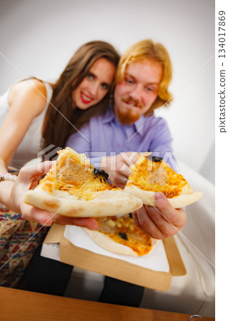 Funny couple eating pizza Funny couple eating pizza 134017869