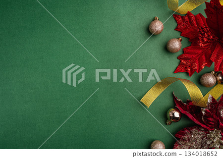 Red Poinsettias and Golden Ornaments on Green Background Red Poinsettias and Golden Ornaments on Green Background 134018652