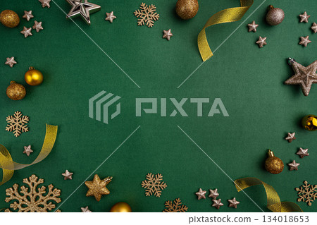 Gold and Green Christmas Ornaments Frame on Green Background Gold and Green Christmas Ornaments Frame on Green Background 134018653