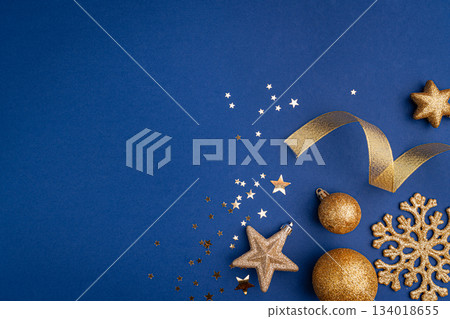 Golden Christmas Ornaments and Stars on Blue Background Golden Christmas Ornaments and Stars on Blue Background 134018655
