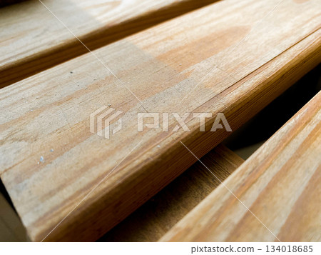 Natural wood planks displaying detailed grain and texture, highlighted by warm sunlight creating shadows and depth, providing organic background or surface. Decorative for design Natural wood planks displaying detailed grain and texture, highlighted by warm sunlight creating shadows and depth, providing organic background or surface. Decorative for design 134018685