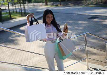 Happy young Asian women shopping gift for holiday, carrying  colorful shopping bags. 134019071
