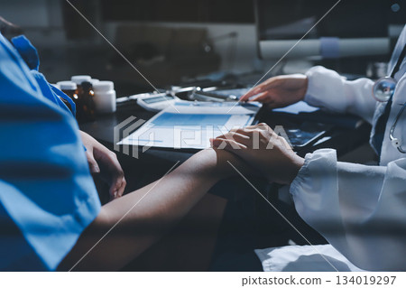 Male doctors shake hands with patients encouraging each other and praying for blessings. To offer love, concern, and encouragement while checking the patient's health. concept of medicine Male doctors shake hands with patients encouraging each other and praying for blessings. To offer love, concern, and encouragement while checking the patient's health. concept of medicine 134019297
