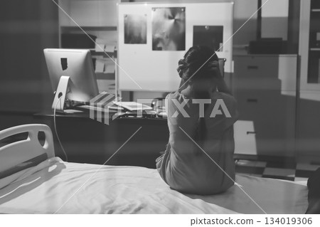 A patient with depression looks outside. A patient with depression looks outside. 134019306