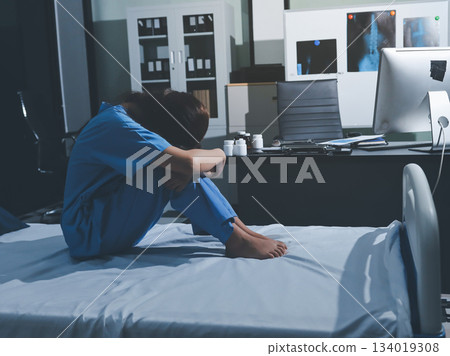 A patient with depression looks outside. A patient with depression looks outside. 134019308