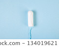Hygienic cotton tampon on blue background. Feminine menstrual hygiene products. Womens health concept. Copy space. 134019621