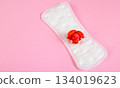 Sanitary pad and red flower on pink background. Menstruation and womens health concept. 134019623