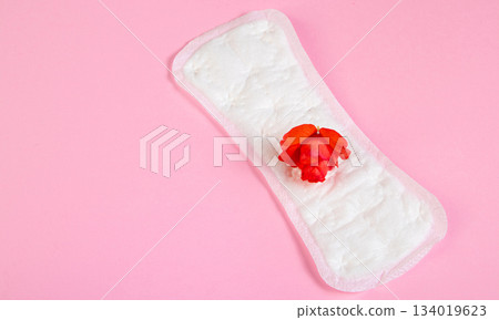 Sanitary pad and red flower on pink background. Menstruation and womens health concept. 134019623