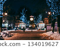 Antique clock in city square. Christmas festive decorations on street. 134019627