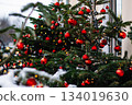 Christmas street decor. Festive trees with Christmas red balls. City decorations for New Year. 134019630