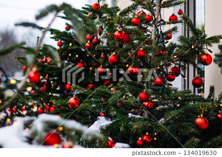 Christmas street decor. Festive trees with Christmas red balls. City decorations for New Year. 134019630