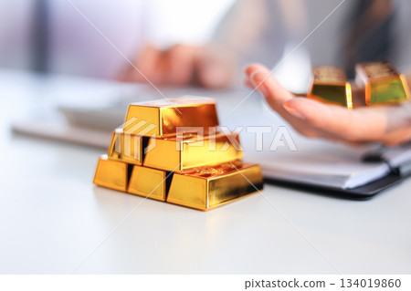 Businessman investing in gold to save assets against inflation and currency depreciation. 134019860