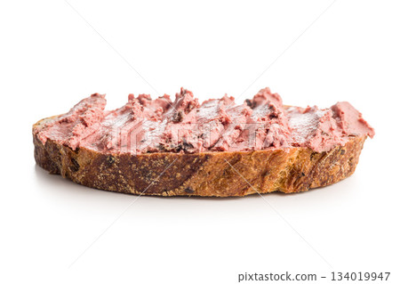 Pate on a slice of bread isolated on white background. Pate on a slice of bread isolated on white background. 134019947