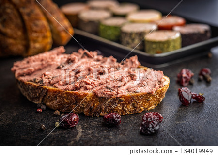 Pate on a slice of bread on black table. Pate on a slice of bread on black table. 134019949