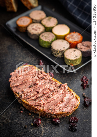 Pate on a slice of bread on black table. Pate on a slice of bread on black table. 134019950